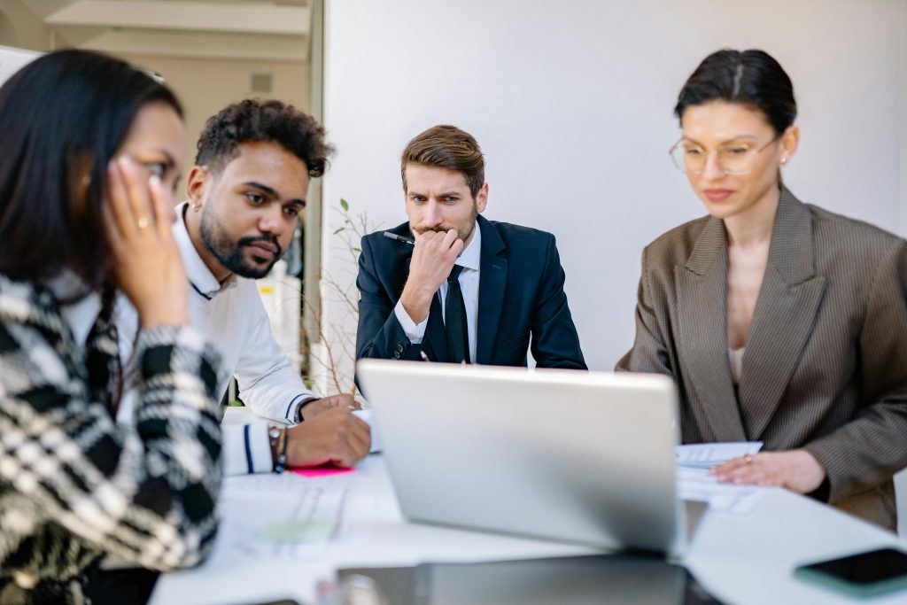 SEO experts discussing strategy around computer screen